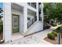 Inviting front entrance featuring a staircase, modern design, and well-maintained landscaping at 8478 Karrer Ter, Orlando, FL 32827
