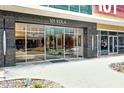 Modern building entrance featuring glass doors, stone accents, and clear signage for easy access to 101 EOLA at 101 S Eola Dr # 810, Orlando, FL 32801