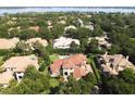Expansive aerial view of a luxury home with a pool, perfectly manicured grounds, and serene lake views at 11013 Ullswater Ln, Windermere, FL 34786