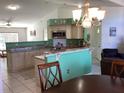 Open kitchen with granite counters, an eat-in bar and a seamless transition into the living area at 116 Blackwater Ct, Kissimmee, FL 34743