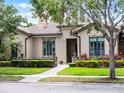 Inviting single-story home with manicured lawn, brick walkway, and well-maintained landscaping at 11755 Waterstone Loop Dr, Windermere, FL 34786