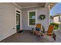Comfortable front porch with seating and a decorative wreath, creating a warm and inviting entrance at 1212 Civitas Way, Winter Garden, FL 34787