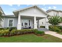Inviting home featuring a charming covered front porch and meticulously landscaped front yard at 1212 Civitas Way, Winter Garden, FL 34787