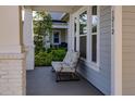 Inviting front porch with a comfortable chair, offering a relaxing outdoor space at 1212 Civitas Way, Winter Garden, FL 34787