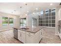 Bright and airy kitchen with a large island, stainless steel appliances, and an open view to living room at 1272 Patterson Ter, Lake Mary, FL 32746