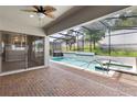 Inviting screened-in pool area with a relaxing spa and lush greenery, perfect for outdoor enjoyment at 1272 Patterson Ter, Lake Mary, FL 32746