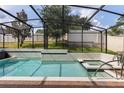 Sparkling pool and spa surrounded by a screen enclosure, offering a private backyard oasis with lush landscaping at 1272 Patterson Ter, Lake Mary, FL 32746