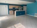 Open-concept kitchen and living area with tile floors and stainless steel appliances at 1921 Stone Abbey Blvd, Orlando, FL 32828