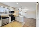 Stylish kitchen with stainless steel appliances, breakfast bar, and an adjacent dining area at 1948 Conway Rd # 8, Orlando, FL 32812