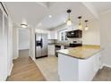 Bright kitchen features stainless appliances, granite counters, white cabinets and a breakfast bar at 1948 Conway Rd # 8, Orlando, FL 32812