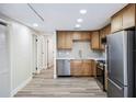 Updated kitchen featuring stainless steel appliances, wood cabinets, quartz counters, and modern flooring at 1957 Deloy Dr, Daytona Beach, FL 32119