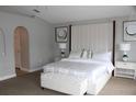 Bright bedroom featuring a padded headboard, white bedding, and neutral decor at 2381 Courtland Blvd, Deltona, FL 32738