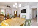 Cozy dining room with wood table and chairs, adjacent to living room with a ceiling fan and modern finishes at 254 Oak Park Pl, Casselberry, FL 32707