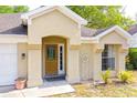 Close-up showcasing a beautifully designed front entrance, wood door, and decorative accents creating curb appeal at 254 Oak Park Pl, Casselberry, FL 32707
