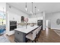 Modern kitchen with a large center island, stainless steel appliances, and sleek white cabinetry at 2643 University Acres Dr, Orlando, FL 32817