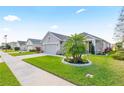 Charming single-story home boasts a well-manicured lawn and lush landscaping at 2941 Marlberry Ln, Clermont, FL 34714