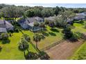 Expansive backyard featuring a screened-in pool area, palm trees, and a fenced yard perfect for outdoor activities at 3840 Caledonia Ave, Apopka, FL 32712