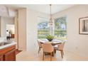 Cozy breakfast nook with scenic pond views, a modern chandelier, and comfortable seating for four at 4301 Heirloom Rose Pl, Oviedo, FL 32766
