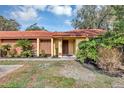 Charming home exterior with manicured landscaping and a classic red tile roof at 5039 Jamaica # 10, Orlando, FL 32808