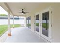 A covered patio provides shade and has a ceiling fan, with views of the spacious backyard at 508 Key Ct, Orlando, FL 32828