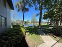 Picturesque backyard view with a serene lake and well-maintained green space at 51 Windtree Ln # 101, Winter Garden, FL 34787