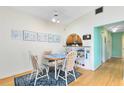 Bright dining area features hardwood floors, stylish decor, and a cozy atmosphere for enjoying meals at 657 Overspin Dr, Winter Park, FL 32789
