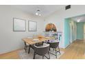 Dining room features light wood floors, dining table with seating for four, and decorative art pieces at 657 Overspin Dr, Winter Park, FL 32789
