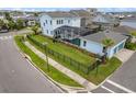 Aerial view of a two-story blue house with a screened pool, fenced yard, and two car garage at 6875 Bridgman St, Orlando, FL 32827