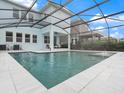 Screened pool with tiled deck is surrounded by an enclosure offering a great outdoor living space at 6875 Bridgman St, Orlando, FL 32827