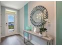 Stylish entryway featuring a decorative mirror, modern console table, and tasteful accents at 746 Mocking Jay Ln, St Cloud, FL 34771