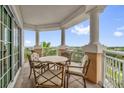 Outdoor seating area with ornate wrought iron chairs and table and scenic views from the columned balcony at 7593 Gathering Dr # 502, Reunion, FL 34747