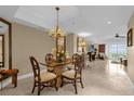 This dining area includes chandelier, large wall mirror, and easy access to the living room and outdoor balcony at 7593 Gathering Dr # 502, Reunion, FL 34747