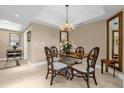 The dining area offers a unique glass-topped dining table with wood chairs, and a decorative chandelier at 7593 Gathering Dr # 502, Reunion, FL 34747