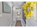 Stylish hallway featuring light wood floors and decorative wall accents at 8202 Sw 123Rd Ter, Dunnellon, FL 34432