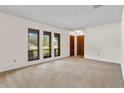 Bright living room with plush carpet and large windows for natural light at 10059 Sali Dr, Orlando, FL 32817