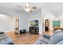 Open-concept living room with hardwood floors, a ceiling fan, and neutral tones at 1014 Seminole Creek Dr, Oviedo, FL 32765