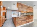 Open kitchen with a breakfast bar, granite countertops, stainless appliances, and ample cabinet space at 106 8Th St, Lake Hamilton, FL 33851