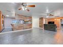 Open-concept living room and kitchen area featuring a unique wood-paneled wall and tiled flooring at 106 8Th St, Lake Hamilton, FL 33851