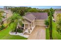 Lovely home featuring beautiful landscaping, a two-car garage, and a charming front porch at 1089 Seburn Rd, Apopka, FL 32703