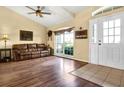 Inviting living room features a comfortable leather sofa, large window, and bright lighting at 11115 Romance Ct, Winter Garden, FL 34787