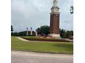 Picturesque community landmark featuring manicured lawn, decorative flowerbeds, and an American flag at 14531 Pleach St, Winter Garden, FL 34787