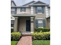 Inviting townhouse featuring a covered entrance and brick walkway at 14531 Pleach St, Winter Garden, FL 34787