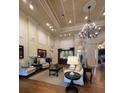 Spacious lounge area with elegant seating, high ceilings, and decorative chandelier at 14531 Pleach St, Winter Garden, FL 34787
