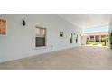 Large carport with direct access to the main home and multiple windows for natural light at 1548 Challenger Ave, Davenport, FL 33897