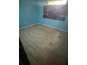 Bedroom with light blue walls and updated floors at 1675 Louis Dr, Kissimmee, FL 34758