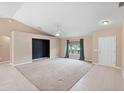 Spacious living room featuring a ceiling fan, neutral paint, and tile/carpet flooring at 2104 E Parkton Dr, Deltona, FL 32725