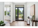 Bright entryway with hardwood floors, modern decor, and a view of the outdoors through a glass door at 2407 Lafayette Ave, Winter Park, FL 32789