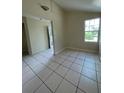 Living room featuring light-colored walls, tile floors and large window at 2414 E Orange Ave, Eustis, FL 32726