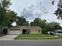 Inviting yellow single-Gathering home with a well-kept lawn and a two-car garage at 243 Country Landing Blvd, Apopka, FL 32703