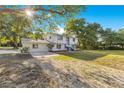 Charming two-story home with lush landscaping and a sun-drenched front yard at 2550 Barren Oak Ct, Deland, FL 32720